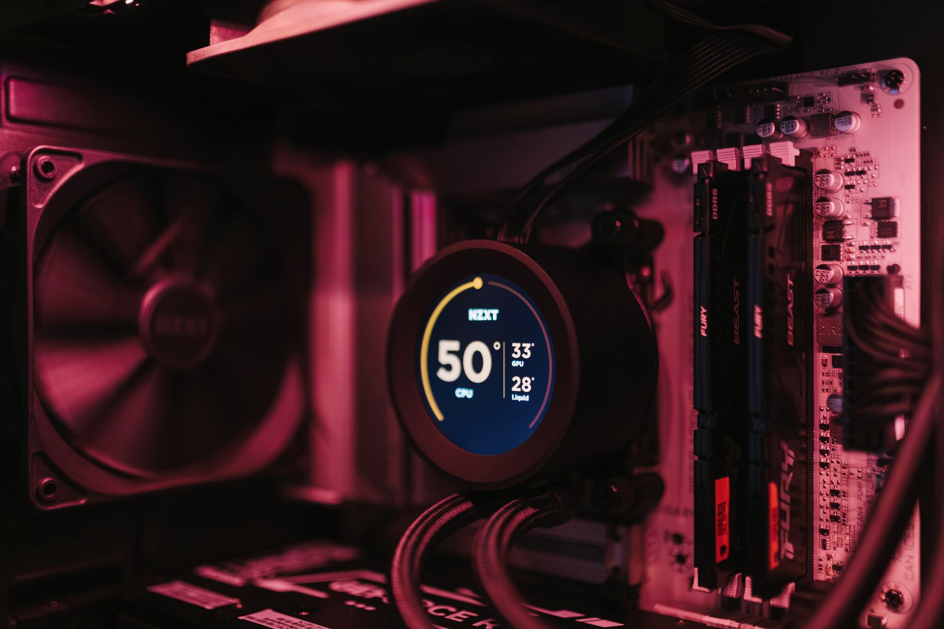 Close-up of a PC cooling system and motherboard, highlighting digital temperature display.